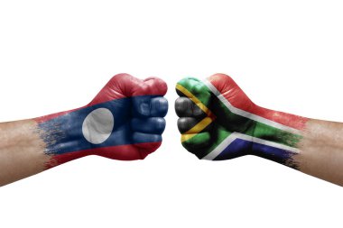 Two hands punch to each others on white background. Country flags painted fists, conflict crisis concept between laos and south africa