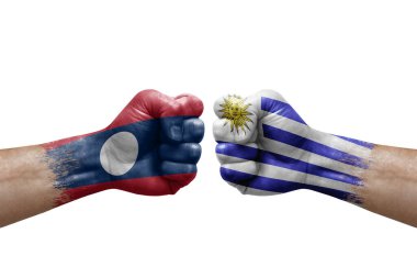 Two hands punch to each others on white background. Country flags painted fists, conflict crisis concept between laos and uruguay