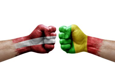 Two hands punch to each others on white background. Country flags painted fists, conflict crisis concept between latvia and mali