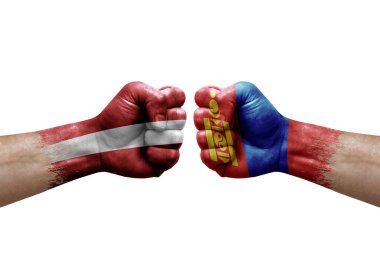 Two hands punch to each others on white background. Country flags painted fists, conflict crisis concept between latvia and mongolia