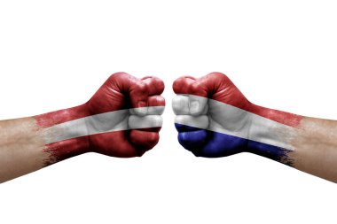 Two hands punch to each others on white background. Country flags painted fists, conflict crisis concept between latvia and netherlands