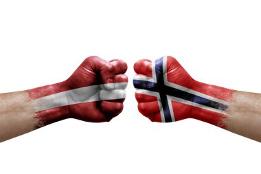 Two hands punch to each others on white background. Country flags painted fists, conflict crisis concept between latvia and norway