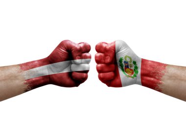 Two hands punch to each others on white background. Country flags painted fists, conflict crisis concept between latvia and peru