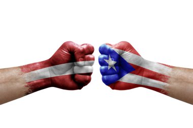 Two hands punch to each others on white background. Country flags painted fists, conflict crisis concept between latvia and puerto rico