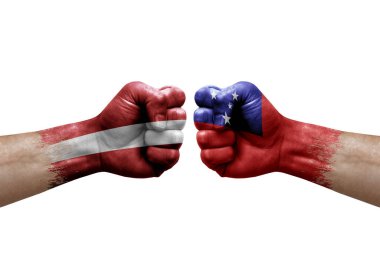 Two hands punch to each others on white background. Country flags painted fists, conflict crisis concept between latvia and samoa