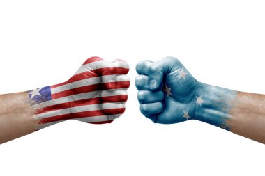 Two hands punch to each others on white background. Country flags painted fists, conflict crisis concept between liberia and micronesia