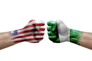 Two hands punch to each others on white background. Country flags painted fists, conflict crisis concept between liberia and nigeria