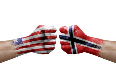 Two hands punch to each others on white background. Country flags painted fists, conflict crisis concept between liberia and norway