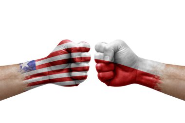 Two hands punch to each others on white background. Country flags painted fists, conflict crisis concept between liberia and poland