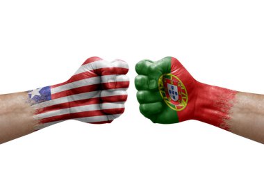Two hands punch to each others on white background. Country flags painted fists, conflict crisis concept between liberia and portugal