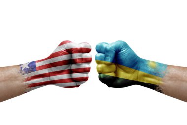 Two hands punch to each others on white background. Country flags painted fists, conflict crisis concept between liberia and rwanda