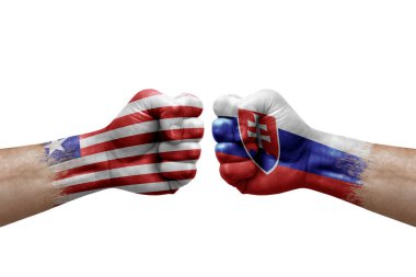 Two hands punch to each others on white background. Country flags painted fists, conflict crisis concept between liberia and slovakia