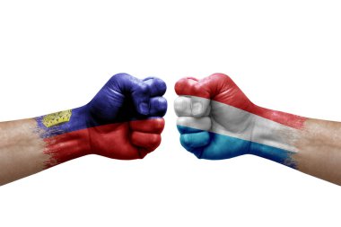 Two hands punch to each others on white background. Country flags painted fists, conflict crisis concept between liechtenstein and luxembourg