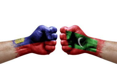 Two hands punch to each others on white background. Country flags painted fists, conflict crisis concept between liechtenstein and maldives