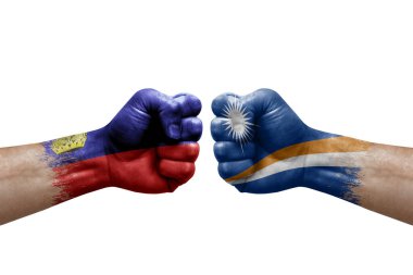 Two hands punch to each others on white background. Country flags painted fists, conflict crisis concept between liechtenstein and marshall islands
