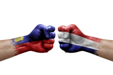 Two hands punch to each others on white background. Country flags painted fists, conflict crisis concept between liechtenstein and netherlands