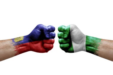 Two hands punch to each others on white background. Country flags painted fists, conflict crisis concept between liechtenstein and nigeria