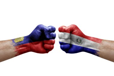Two hands punch to each others on white background. Country flags painted fists, conflict crisis concept between liechtenstein and paraguay
