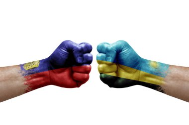 Two hands punch to each others on white background. Country flags painted fists, conflict crisis concept between liechtenstein and rwanda