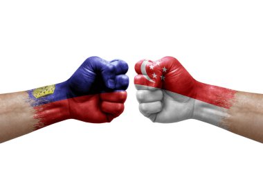 Two hands punch to each others on white background. Country flags painted fists, conflict crisis concept between liechtenstein and singapore