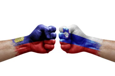 Two hands punch to each others on white background. Country flags painted fists, conflict crisis concept between liechtenstein and slovenia