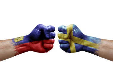 Two hands punch to each others on white background. Country flags painted fists, conflict crisis concept between liechtenstein and sweden