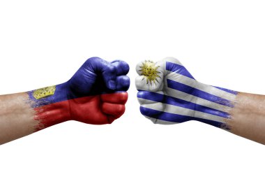 Two hands punch to each others on white background. Country flags painted fists, conflict crisis concept between liechtenstein and uruguay