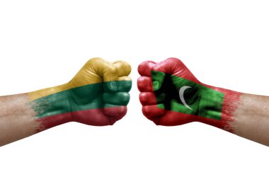 Two hands punch to each others on white background. Country flags painted fists, conflict crisis concept between lithuania and maldives