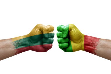Two hands punch to each others on white background. Country flags painted fists, conflict crisis concept between lithuania and mali