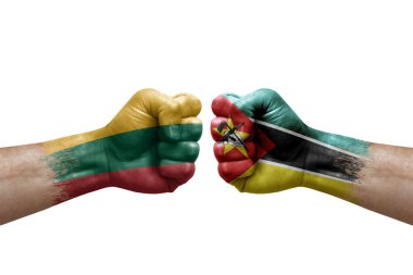 Two hands punch to each others on white background. Country flags painted fists, conflict crisis concept between lithuania and mozambique