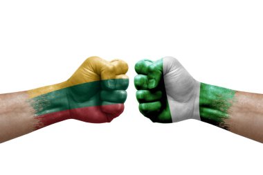 Two hands punch to each others on white background. Country flags painted fists, conflict crisis concept between lithuania and nigeria
