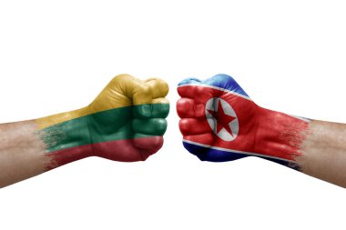 Two hands punch to each others on white background. Country flags painted fists, conflict crisis concept between lithuania and north korea