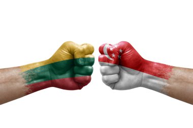 Two hands punch to each others on white background. Country flags painted fists, conflict crisis concept between lithuania and singapore