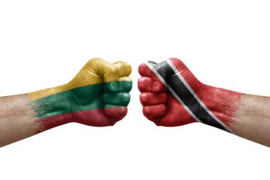 Two hands punch to each others on white background. Country flags painted fists, conflict crisis concept between lithuania and tobago