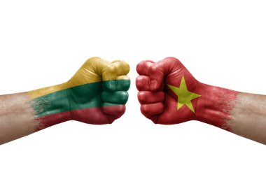 Two hands punch to each others on white background. Country flags painted fists, conflict crisis concept between lithuania and vietnam