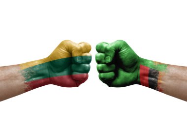 Two hands punch to each others on white background. Country flags painted fists, conflict crisis concept between lithuania and zambia