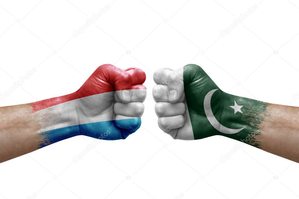 Two hands punch to each others on white background. Country flags painted fists, conflict crisis concept between luxembourg and pakistan