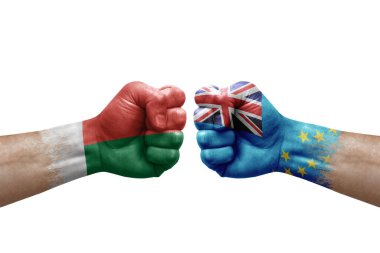Two hands punch to each others on white background. Country flags painted fists, conflict crisis concept between madagascar and tuvalu