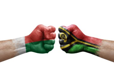 Two hands punch to each others on white background. Country flags painted fists, conflict crisis concept between madagascar and vanuatu
