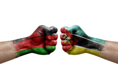 Two hands punch to each others on white background. Country flags painted fists, conflict crisis concept between malawi and mozambique