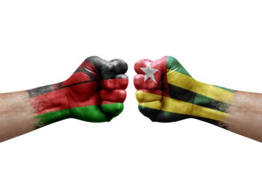Two hands punch to each others on white background. Country flags painted fists, conflict crisis concept between malawi and togo