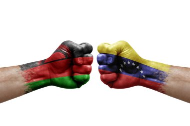 Two hands punch to each others on white background. Country flags painted fists, conflict crisis concept between malawi and venezuela