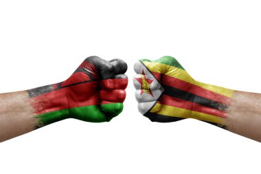 Two hands punch to each others on white background. Country flags painted fists, conflict crisis concept between malawi and zimbabwe