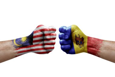 Two hands punch to each others on white background. Country flags painted fists, conflict crisis concept between malaysia and moldova