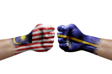 Two hands punch to each others on white background. Country flags painted fists, conflict crisis concept between malaysia and nauru