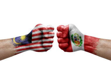 Two hands punch to each others on white background. Country flags painted fists, conflict crisis concept between malaysia and peru