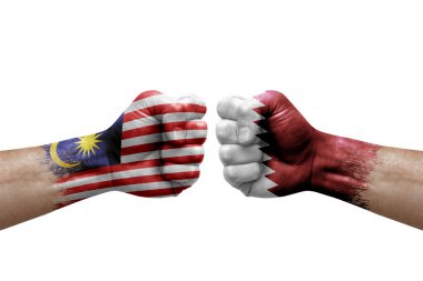 Two hands punch to each others on white background. Country flags painted fists, conflict crisis concept between malaysia and qatar