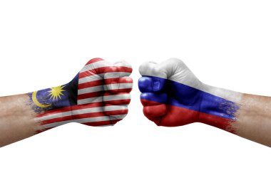 Two hands punch to each others on white background. Country flags painted fists, conflict crisis concept between malaysia and russia