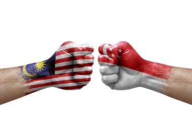 Two hands punch to each others on white background. Country flags painted fists, conflict crisis concept between malaysia and singapore