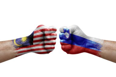 Two hands punch to each others on white background. Country flags painted fists, conflict crisis concept between malaysia and slovenia